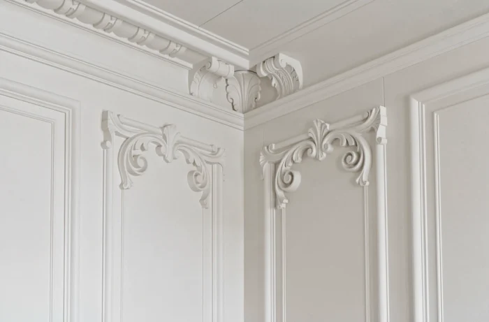 Moulures en staff redessinées par scan 3D dans un appartement haussmannien, réinterprétant des motifs classiques d'acanthe en version contemporaine peinte en blanc craie.